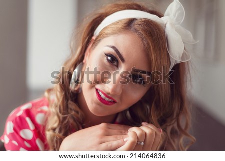 Close up portrait of Pin Up Girl with perfect make up and red shirt with polka dots