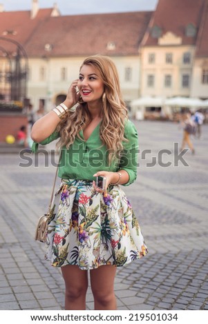 Fashion elegant stylish woman posing on streets of European city in summer evening weather. Sensual blonde vogue girl street style portrait