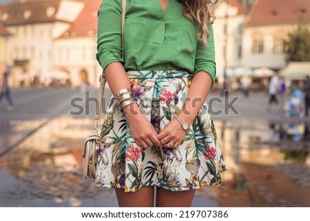 Outfit details of fashion elegant stylish woman posing on city streets in summer evening weather. Sensual blonde vogue girl street style shooting