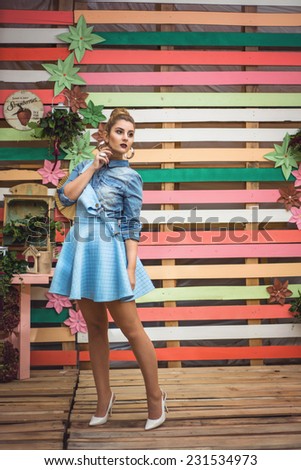 Colorful decor Studio Shot of Fashion Woman posing straight. Vivid Colors. Rainbow Colors painted on wood. Vintage objects