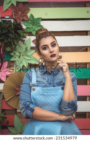 Beauty Girl Portrait with baby blue dress. Colorful decor Studio Shot of Fashion Woman. Vivid Colors. Rainbow Colors painted on wood. Vintage objects