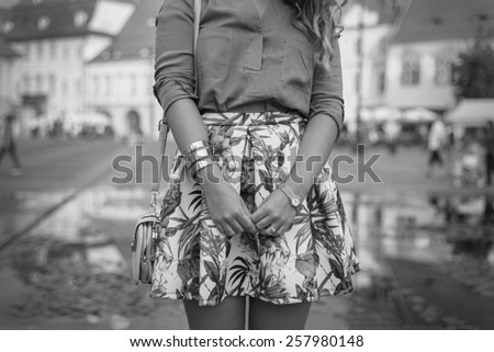 Black and  White Outfit details of fashion elegant stylish woman posing on streets of European city in summer evening weather. Sensual blonde vogue girl street style shooting