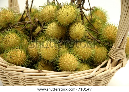 A basket of rambutans, a south east asian sweet, hairy fruit which come in yellow, pink and red varieties