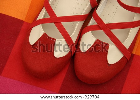 Dance shoes on red cushion