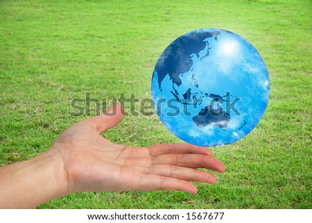 The world in your hand with green grassy background