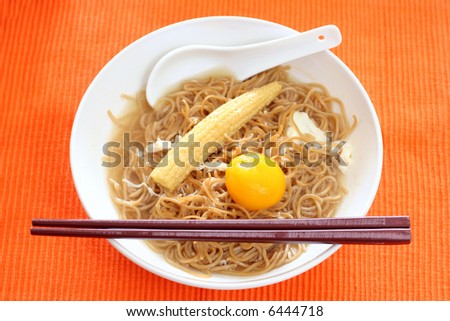 Brown Chinese buckwheat noodles with egg and baby corn in light soup