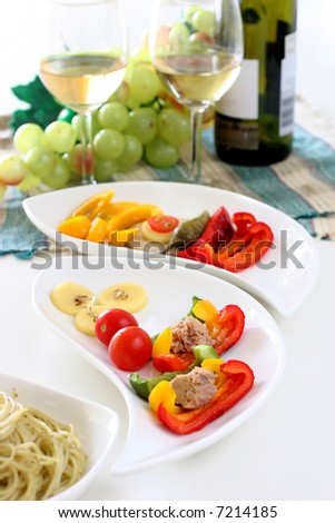 Healthy colorful vegetable platter with assorted vegetables, fish and biscuits