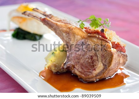 Seared and roasted lamb ribs with baked potato, tomato puree and breadcrumbs