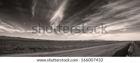 Black and white panorama of steppe road in Kazakhstan