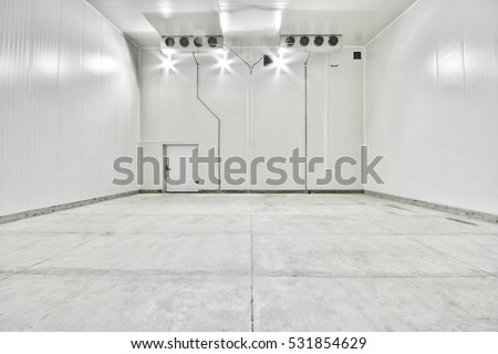 an empty industrial room refrigerator with eight fans