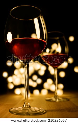 2 glasses of red wine. Christmas, romantic, valentine dinner image.