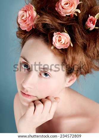 Artistic portrait of young girl with Marie Antoinette hairstyle updo. Natural make up with pink cheek and lips.