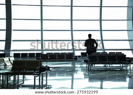 Silhouette of businessman waiting in the airport. station. Short break of businessman.
