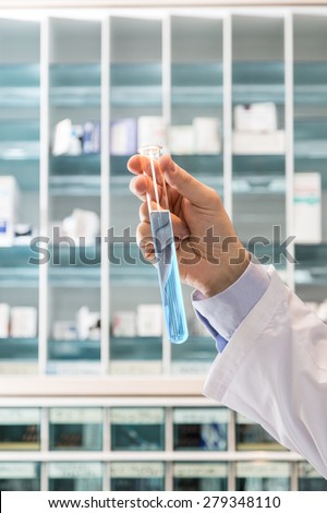 Chemical lab.Medicine test. Man holding a test tube in the lab. Medicine test and research.