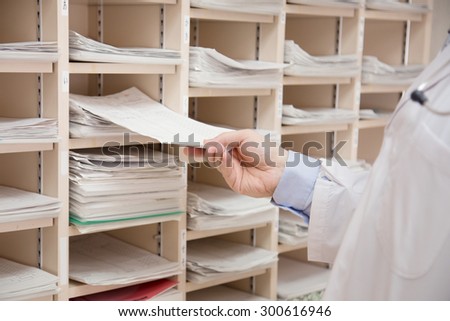 A doctor checking a record card of patients. hospital. medical check.