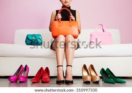 Colorful shoes and bags with woman sitting on the sofa. Shopping and fashion images.