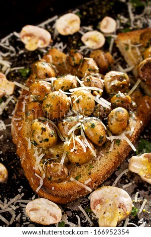 Fried mushrooms with garlic, parsley and grana padano cheese on toasted rustic bread