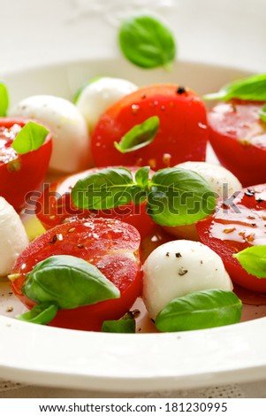 Fresh Caprese salad; mini mozzarella , cherry tomatoes, olive oil and basil