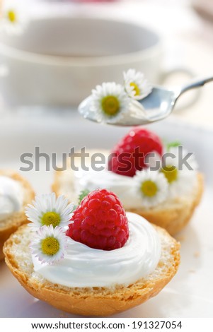 Delicious breakfast. Buttery buns with creamy cheese and fresh raspberries
