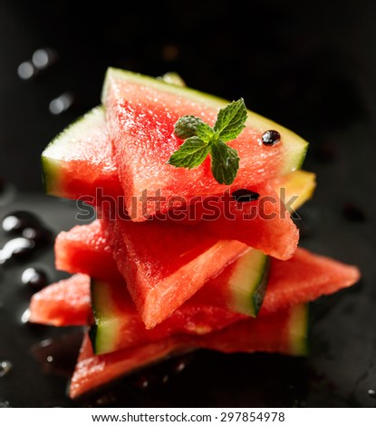 Fresh sliced watermelon on black background
