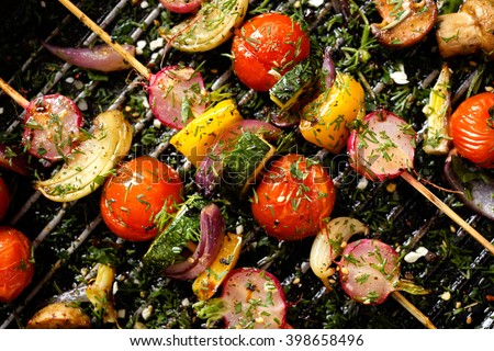 Grilled veggie skewers with cherry tomatoes, radishes, peppers and onions with fresh dill on a grill pan