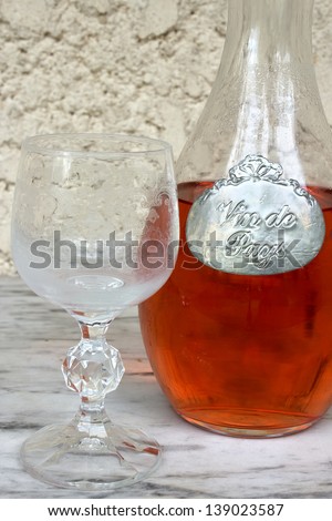 Traditional french decanter of pink wine with a metallic label saying \