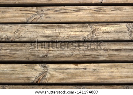 Texture of wooden rows. Photo is taken on the beach, the wooden road to the water.