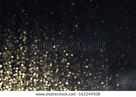 Christmas gold light bokeh in the corner on dark blue background