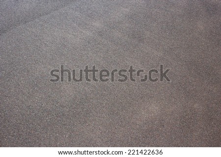 Volcanic black sand texture. Photo is taken on the natural beach on Madeira island, Portugal.