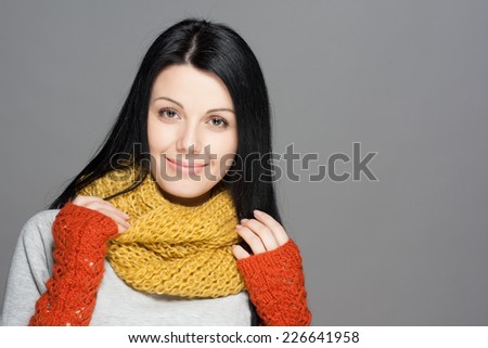 Winter Beauty Woman. Fashion Girl Concept. Skin and hair care in cold season. Beautiful woman with long hair wearing a sweater, scarf, hat and gloves. Holiday Fashion Portrait.