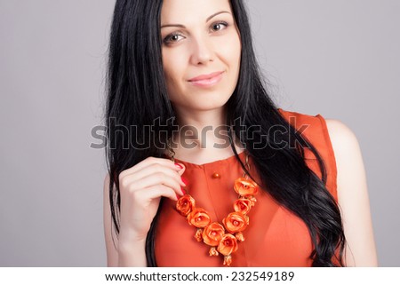 Close-up portrait of beautiful brunette woman with earring jewelry. Fashion photo. Long and healthy hair concept.