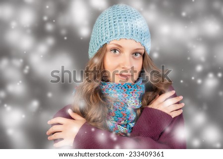 Winter Beauty Woman. Fashion Girl Concept. Skin and hair care in cold season. Beautiful woman with long hair wearing a sweater, scarf and hat. Holiday Fashion Portrait.