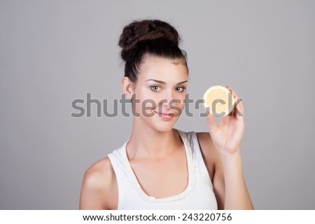 Beautiful close-up young woman with lemons. Healthy food concept. Skin care and beauty. Vitamins and minerals.