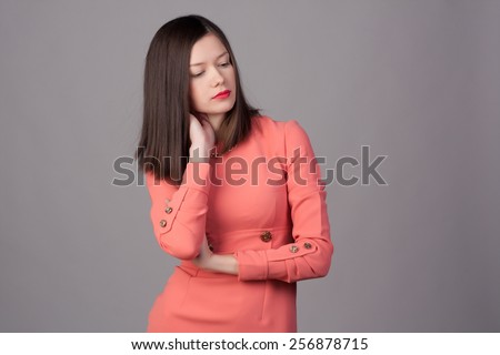 Beautiful close-up portrait of an young woman with short brown haircut wearing red lipstick on studio background. Haircut. Beautiful Girl with Healthy Straight Blond Hair. Hairstyle