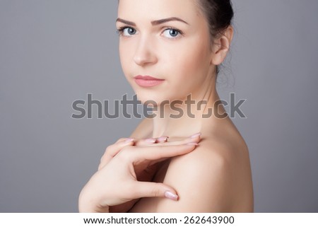Portrait of an young girl with beautiful smile. Close-up portrait of a beautiful young woman. Skin and hair care concept. Natural look. Beauty portrait. Spa and health.