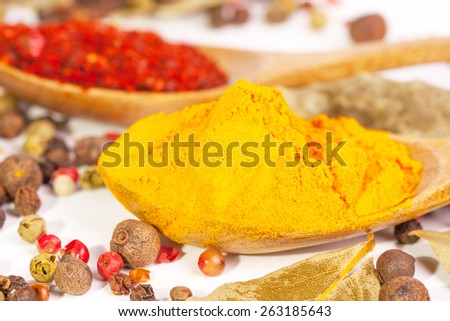 Spices. Spice in Wooden spoon. Herbs. Curry, Saffron, turmeric, cinnamon and other isolated on a white background. Pepper. Large collection of different spices and herbs isolated on white background