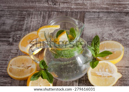 refreshing citrus lemonade,summer drink. Lemonade with fresh lemon on wooden background