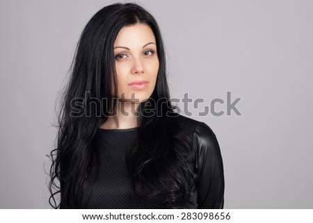 Close-up portrait of beautiful brunette woman with earring jewelry. Fashion photo. Long and healthy hair concept.