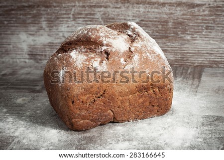 retro bread in rustic style background.Fresh traditional bread on wooden ground with flour in a sack.