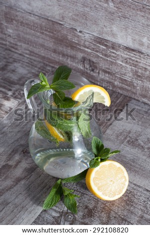 refreshing citrus lemonade,summer drink. Lemonade with fresh lemon on wooden background