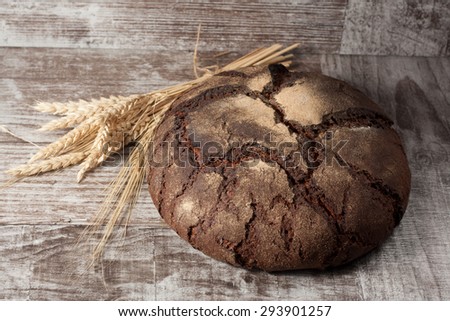 retro bread in rustic style background.Fresh traditional bread on wooden ground with flour in a sack. wheat germs and flour.
