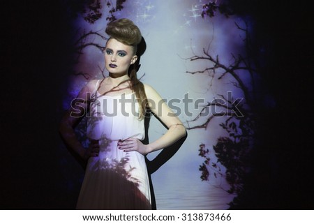Fashion, creative portrait, woman with color image on her face and body. Image projection.