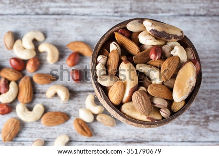 Healthy mix nuts on wooden background. Almonds, hazelnuts, cashews, peanuts, brazilian nuts
