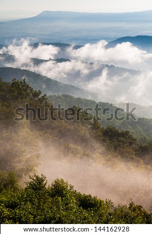 Fog and low clouds clear out of the Blue Ridge after a summer thunderstorm in Shenandoah National Park, Virginia.