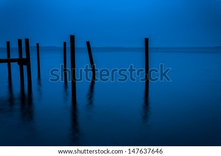 Pier pilings seen during twilight in the Chesapeake Bay, Havre de Grace, Maryland.