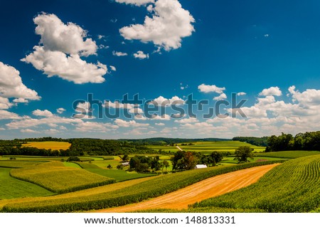 Beautiful summer clouds over rolling hills and farm fields in rural York County, Pennsylvania.