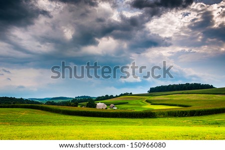 Storm clouds over rolling hills and farm fields in Southern York County, Pennsylvania.