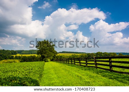 Clouds over fence and farm fields in rural York County, Pennsylvania.