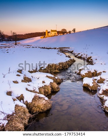 Stream and barn in a snow-covered farm field in eastern York County, Pennsylvania.