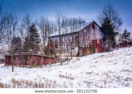 Old barn and a snow covered field in rural York County, Pennsylvania.